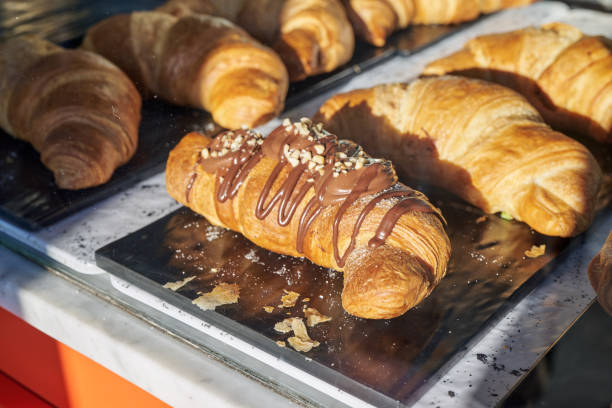 istock Fresh croissants drizzled with chocolate 2204559529