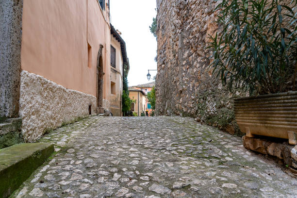 typical cobbled pedestrian street of an old rural village in southern Italy, emanating peace and tranquillity