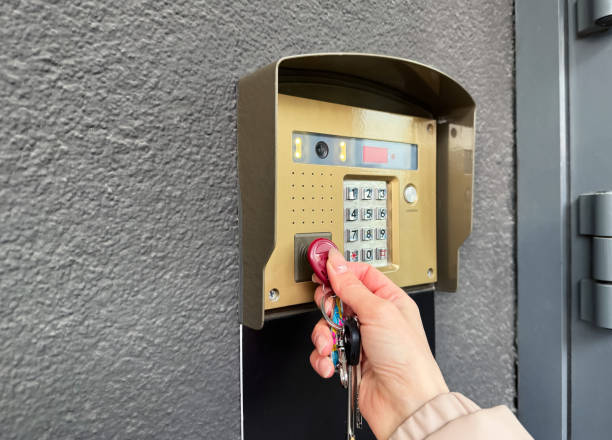 istock A woman's hand using the key to the intercom outside the house to get inside 2204561552