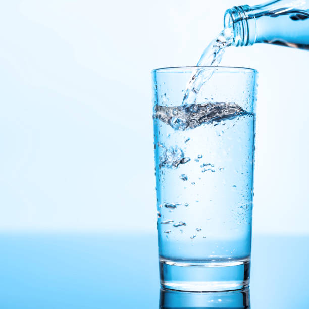 istock Crystal clear water being poured into a transparent glass, creating refreshing ripples and bubbles 2204563973
