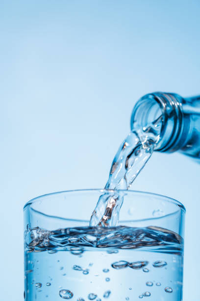 istock Crystal clear water being poured into a transparent glass, creating refreshing ripples and bubbles 2204564050