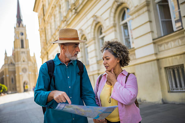 istock Senior couple exploring new city with map. Searching for places. 2204567221