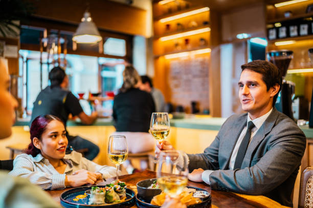 istock Coworkers talking at restaurant 2204567782