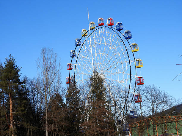 istock Ferries wheel with red, yellow, blue cabins 2204568475