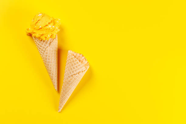 istock A refreshing ice cream cones set against a vibrant yellow background 2204568599