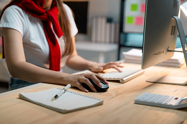 istock Female hands operating computer mouse and keyboard, working productively at home workspace with focused precision 2204569055