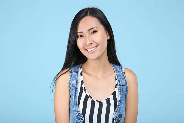 istock Beautiful young woman on blue background 2204572750