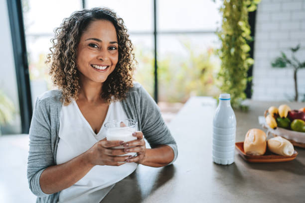 istock Woman drinking milk looking at camera 2204572961