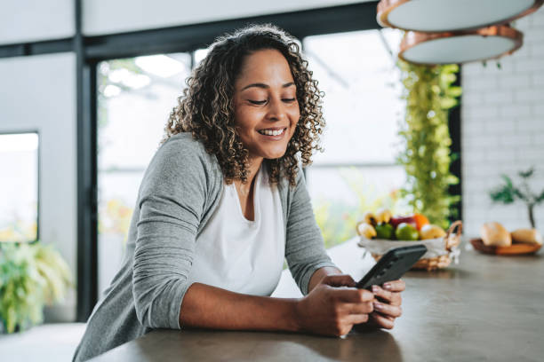 istock Seated woman using smartphone 2204573102