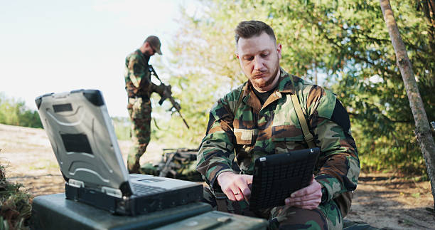istock The serious and experienced army commander sits in the field, having a video conversation with the head of the army base, discussing mission details, security precautions, and classified information. 2204573489