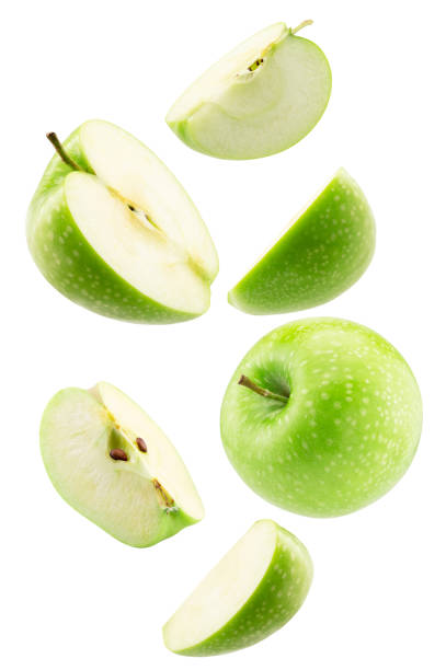 istock falling green apple with slices isolated on a white background 2204573860