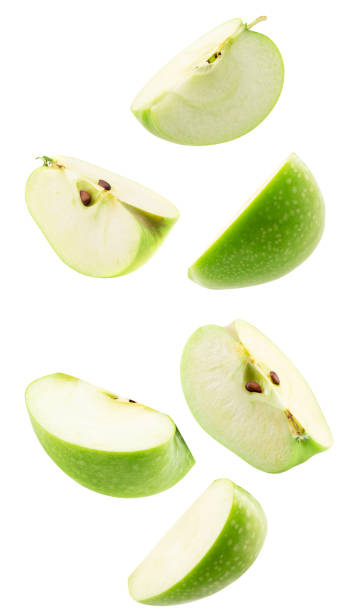 istock falling green apple with slices isolated on a white background 2204573971