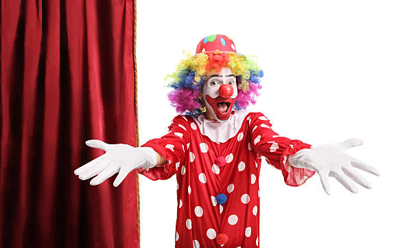 Two creepy clowns hanging out by a brick wall waiting to attack.