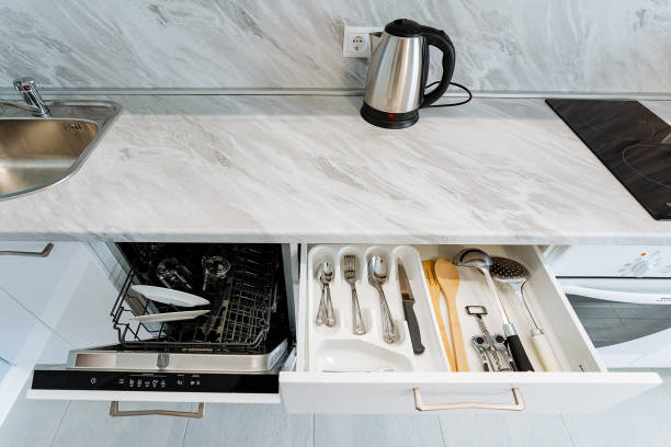 istock The kitchen is equipped with a sleek, modern dishwasher along with a spacious drawer filled with an array of utensils, making it perfect for all your meal preparation and cooking needs 2204576265