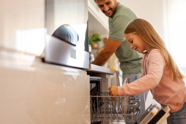 istock Supportive Dad Guiding Preschooler in Kitchen Cleanup Duties 2204576498