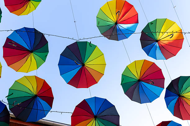 istock Colorful umbrellas suspended in the sky 2204576736
