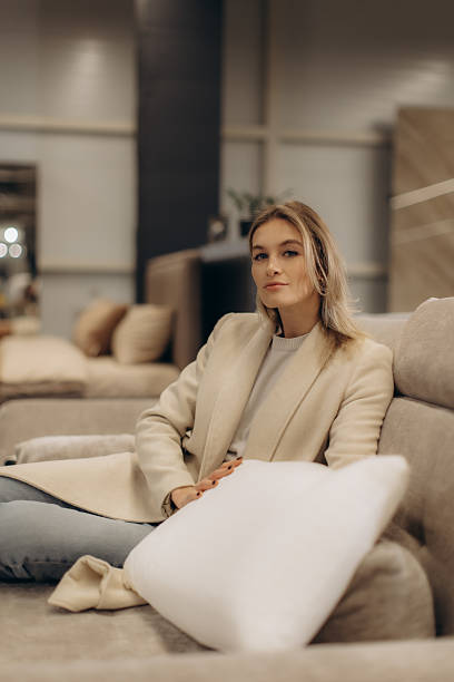 istock Young Woman Relaxing on Modern Sofa in Stylish Indoor Setting 2204577323