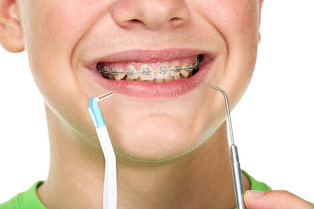 istock Young man with toothbrush and dentist tool on white background 2204577803