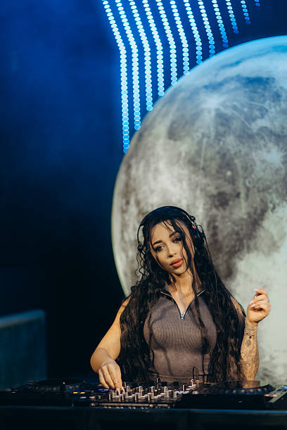 istock Female DJ Performing a Night Show With Futuristic Lighting Effects 2204578543