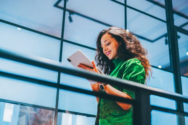 istock Confident businesswoman using a digital tablet in a modern office 2204578888