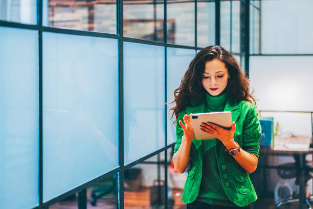 istock Confident businesswoman using a digital tablet in a modern office 2204579023