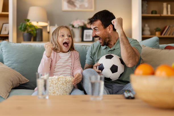 istock Little Girl Learning to Love Soccer While Watching with Her Father 2204579581