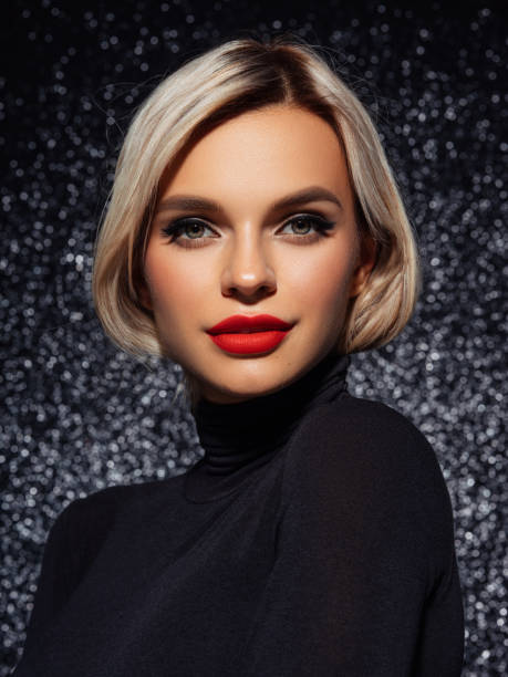 istock Stylish woman with bold red lips against sparkling glittery backdrop 2204582696