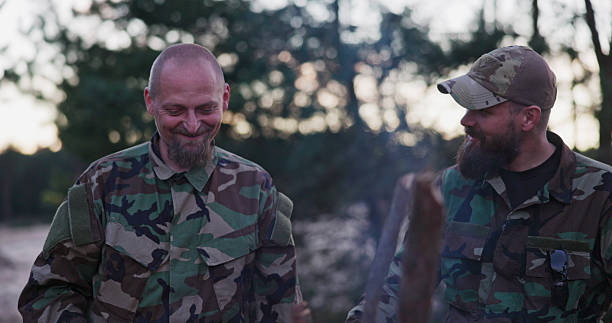 istock Soldiers in combat uniforms talk among themselves, planning their next steps, assessing the terrain, and strategizing for the success of their mission. 2204583366
