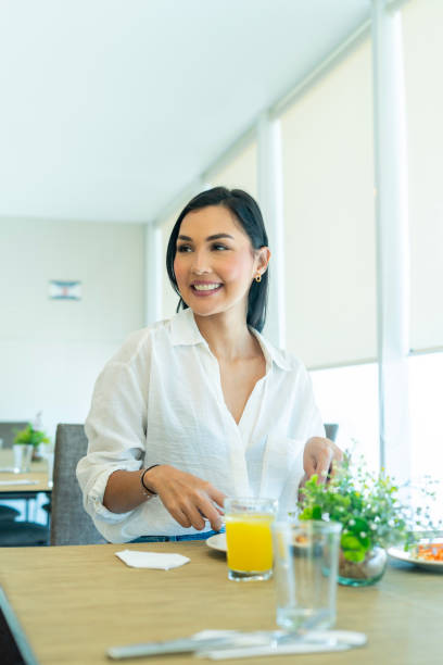 istock Happy woman having lunch in restaurant 2204583936