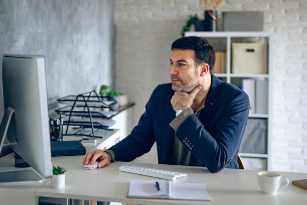 istock Handsome businessman working in his office 2204584173