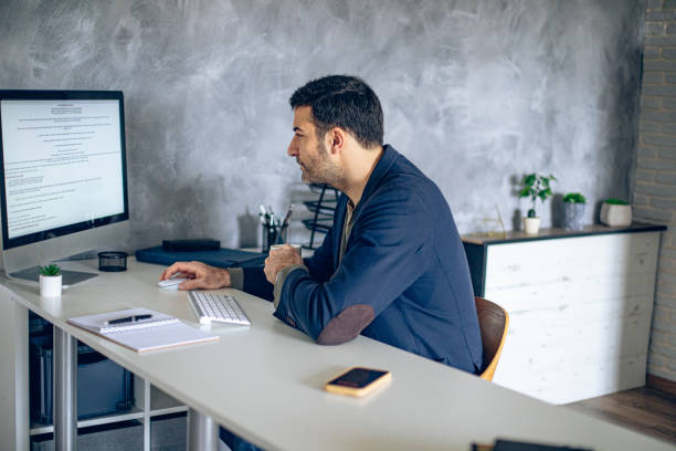 istock Handsome businessman working in his office 2204584296