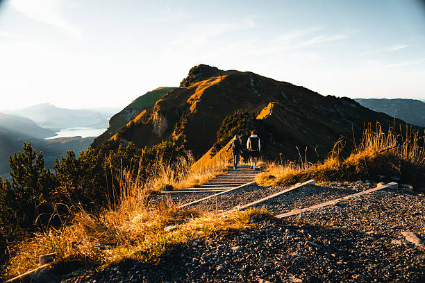 istock Hikers on pathway above lakes and mountains 2204585348