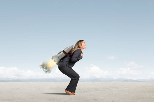 istock Woman With Rocket Strapped To Her Back 2204585570
