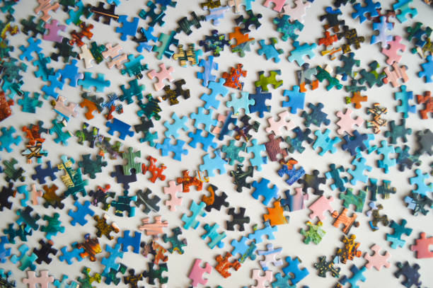 istock Scattered Puzzle Pieces on a Table - Concept of Chaos and Problem Solving 2204587502