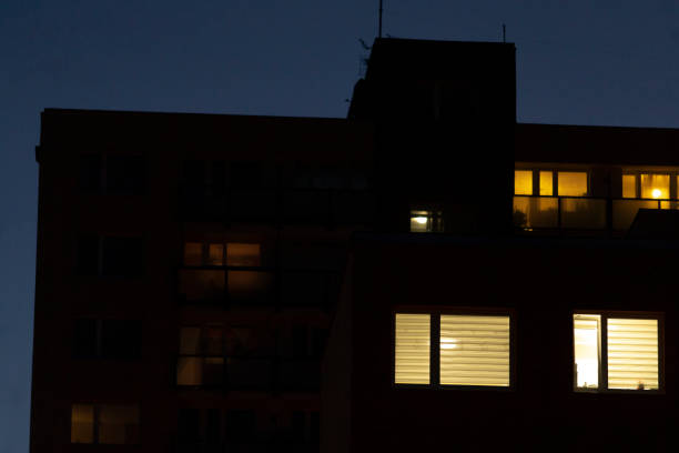 istock A tall building with numerous windows shines brightly during the night 2204587736