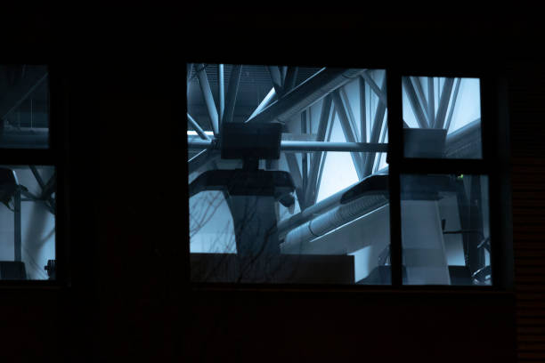 istock A captivating view of a building seen through a window at night 2204588365