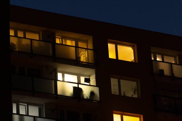 istock A tall building featuring numerous windows that are illuminated at night 2204589361