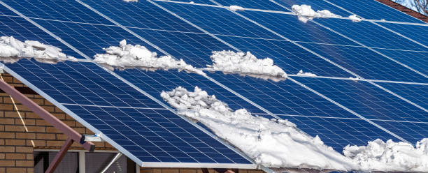 istock Partial snow cover on rooftop solar panels creates a striking contrast on a bright, sunny winter day. 2204590057