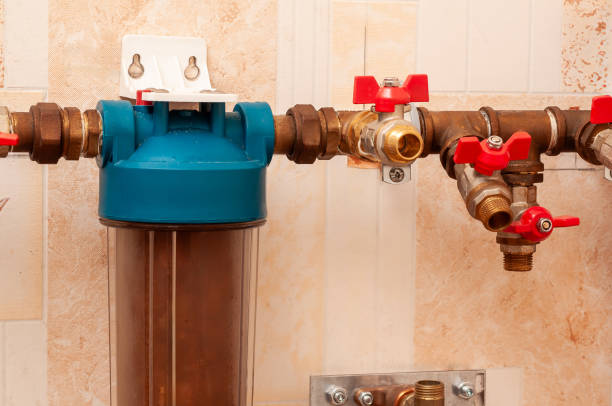 istock A water filtration system installed on a tiled wall, complete with pipes, valves, and sediment filter. 2204590130