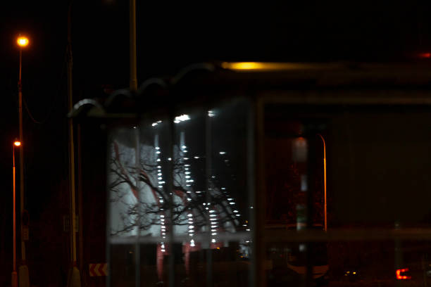 In a shadowy and dimly lit room, there is a sign prominently displayed that simply says the letter K on its surface