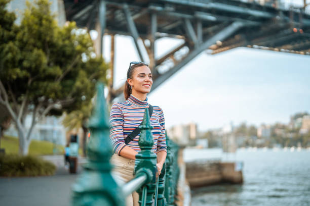 istock Young Hispanic Woman Exploring Sydney Harbor on Sunny Afternoon 2204591428