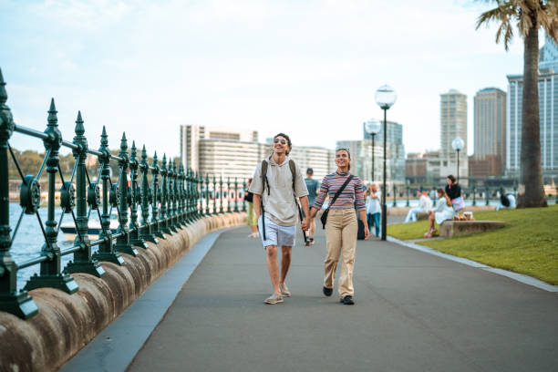 istock Excited Young Couple Strolling Sydney Harbour Promenade 2204591437