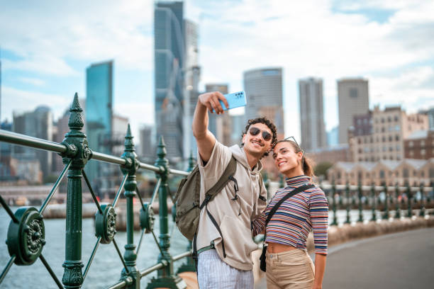 istock Smiling Hispanic Couple Taking Selfie in Sunny Sydney 2204591468