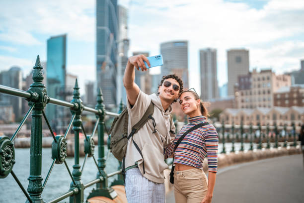 istock Young Hispanic Couple Taking a Selfie in Sydney Harbor 2204591480