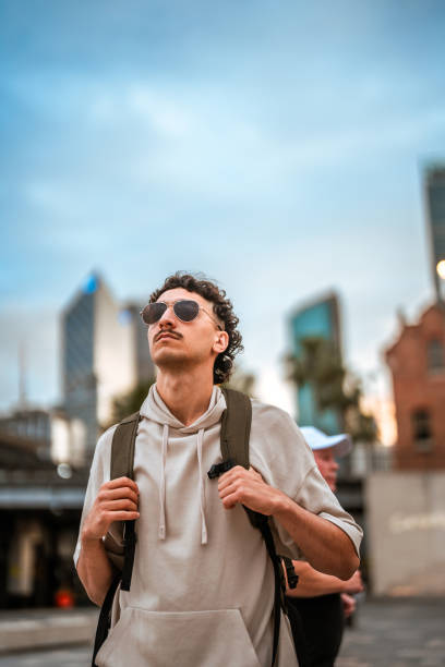 istock Curly-Haired Young Hispanic Male Exploring Sydney Streets 2204591517