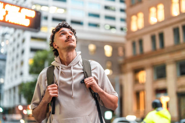 istock Curious Hispanic Male Exploring Sydney Urban Streets at Dusk 2204591590