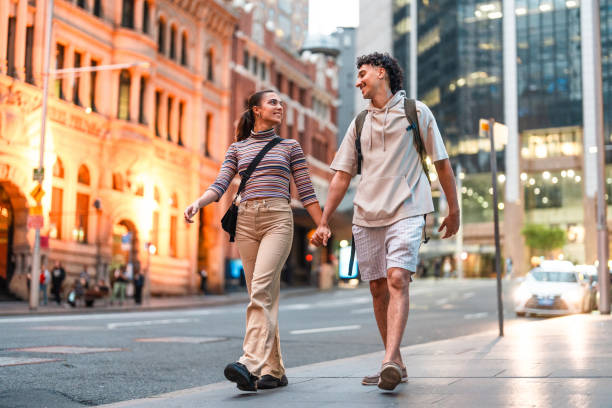 istock Curious Hispanic Couple Strolling Sydney Streets at Sunset 2204591599