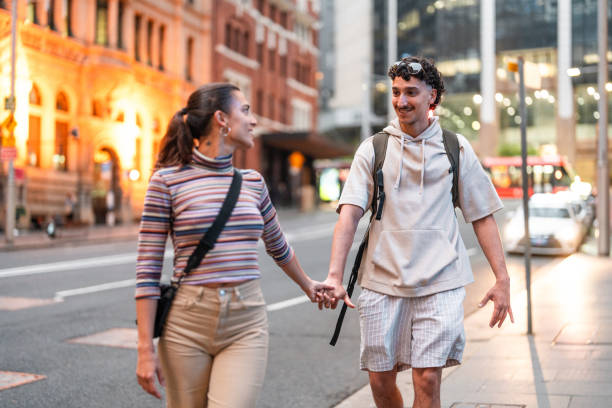 istock Hispanic Couple Strolling Sydney Streets at Sunset 2204591602