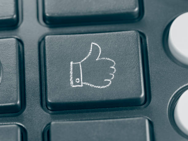 istock Thumbs up sign drawn in chalk on a push button 2204594401