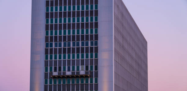 high-rise glass building at twilight.
